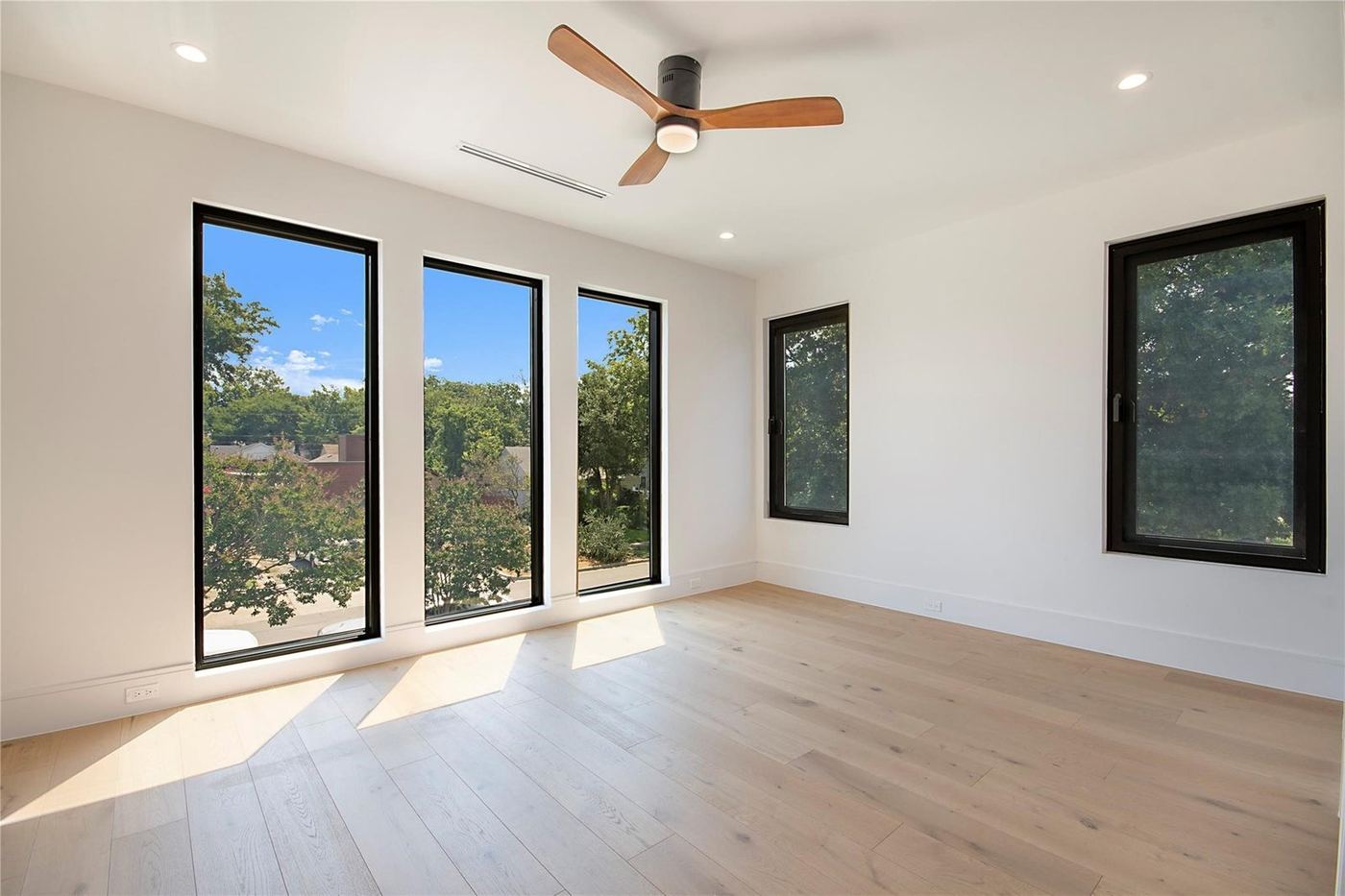 Bedroom with three tall black-frame windows