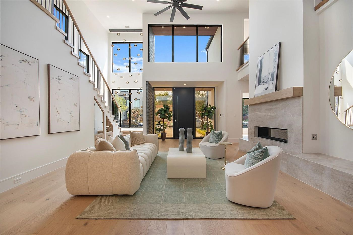 Two-story living room with a wall of black-frame windows
