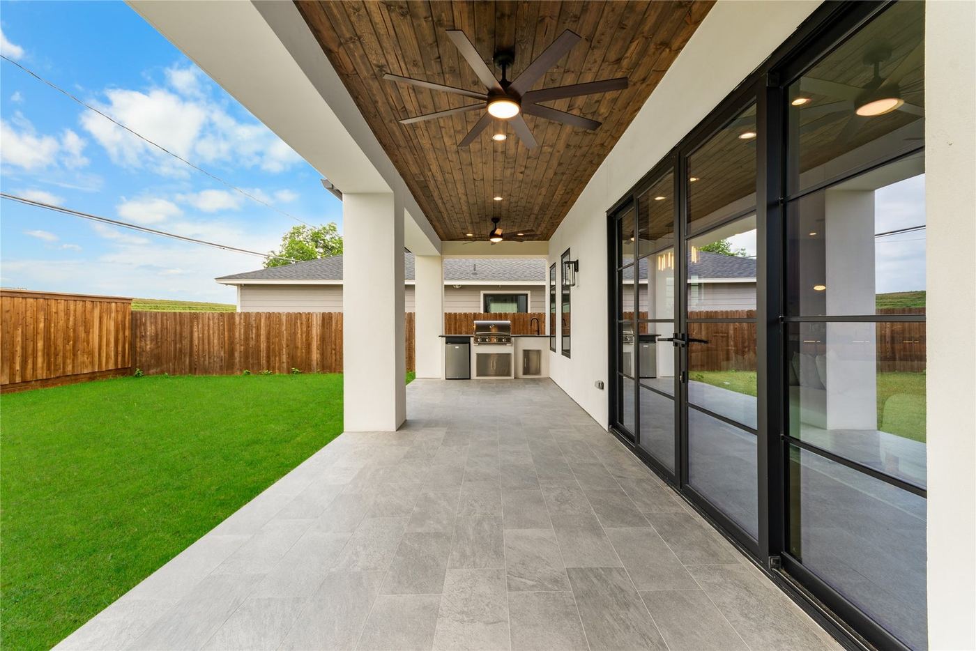 Sliding glass wall opening onto a covered patio